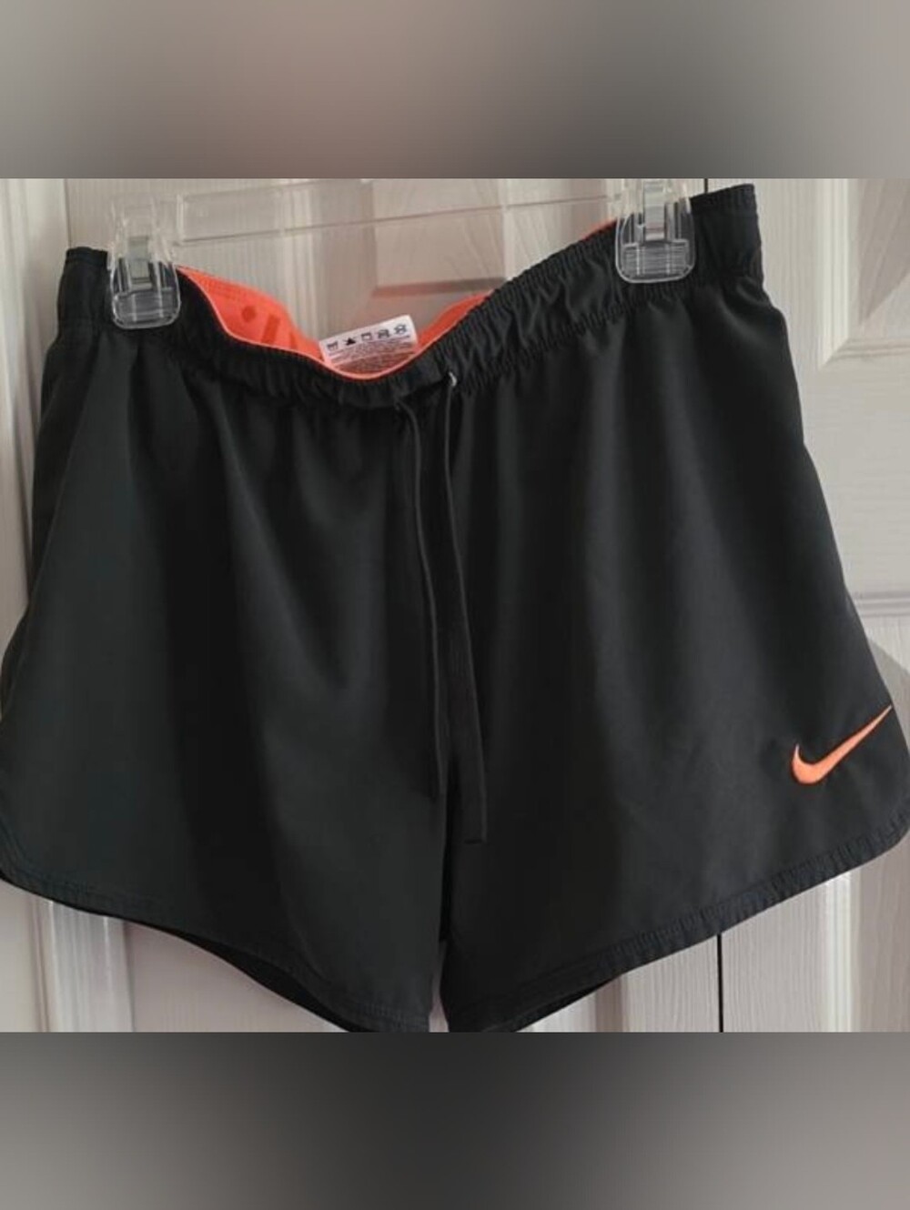 Nike Women's Black Athletic Shorts with Orange Swoosh